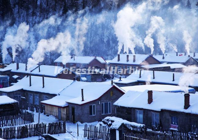  Smoke from Cooking Stoves Floating Above the Roofs of Village Houses in China's Snow Town 