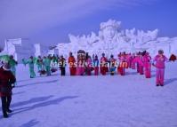 A Group of Old Women Perform the Yangko in Front of a Giant Snow Sculpture on Sun Island