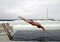 A Winter Swimmer Take a Dive at Harbin Ice Festival 