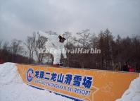 A Tourist Enjoys Snowboarding in Harbin Longzhu Erlongshan Ski Resort